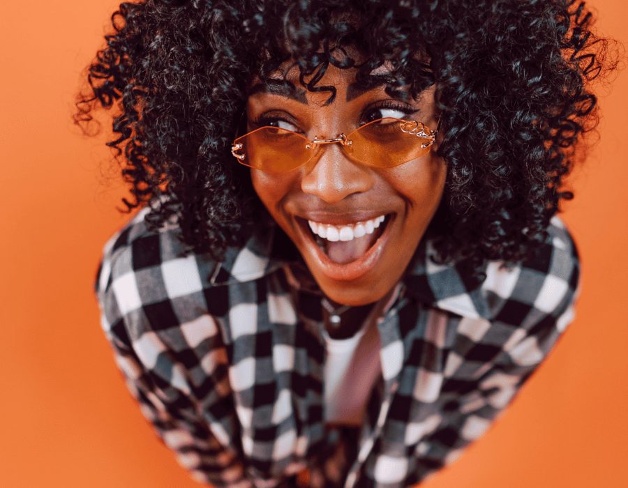a woman with curly hair and glasses