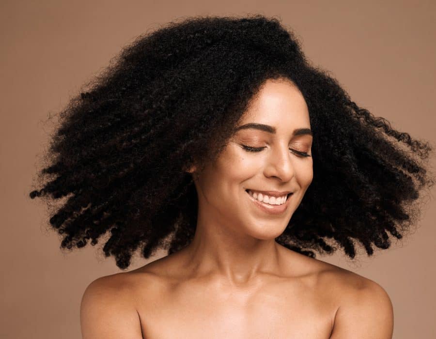 a woman with curly hair smiling