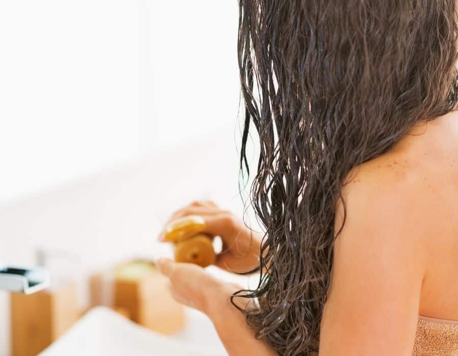 Woman applying hair mask